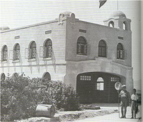 Hully and Jack Burroughs in front of the garage building in the '20s